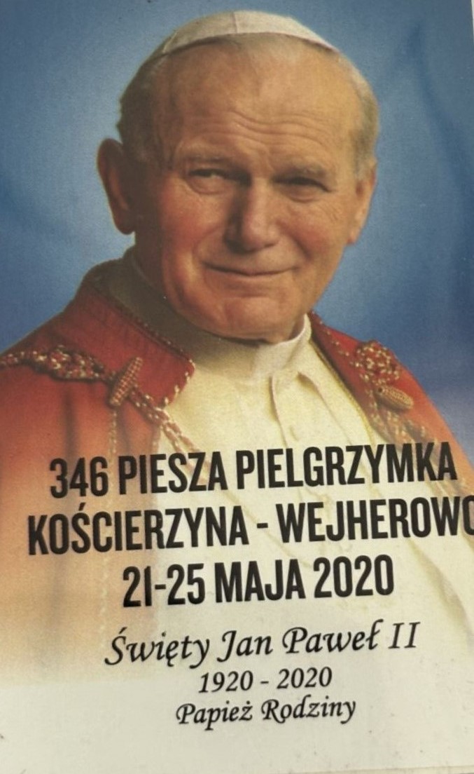 Prostokątna plakietka z pielgrzymki. Na plakietce wizerunek papieża Jana Pawła II.